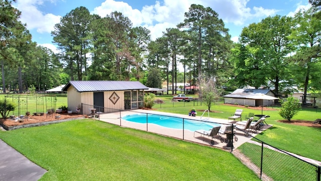 view of swimming pool featuring a patio area, a lawn, and an outdoor structure