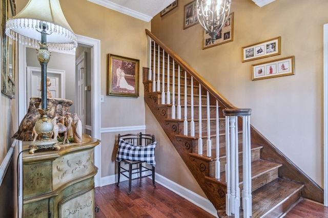 stairway featuring hardwood / wood-style floors, ornamental molding, and a chandelier