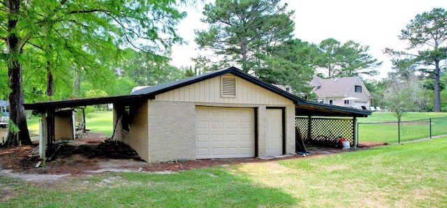 garage with a yard and a carport