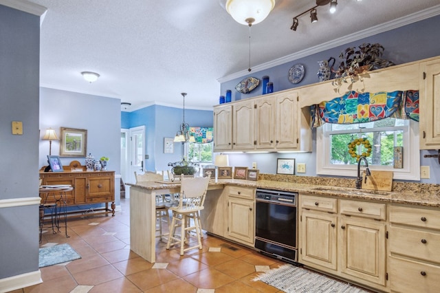 kitchen with sink, hanging light fixtures, black dishwasher, and a textured ceiling