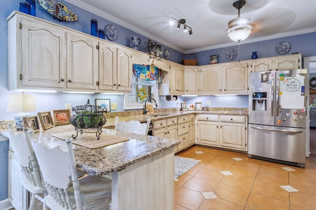 kitchen with stainless steel refrigerator with ice dispenser, sink, kitchen peninsula, light stone counters, and light tile patterned floors