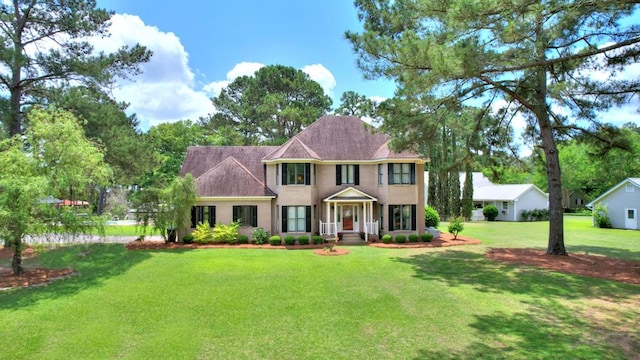 colonial-style house with a front lawn