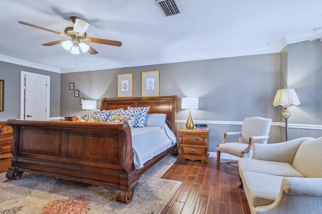 bedroom featuring a textured ceiling, dark hardwood / wood-style floors, ceiling fan, and ornamental molding