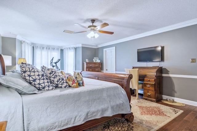 bedroom featuring dark wood-type flooring, a textured ceiling, ceiling fan, and ornamental molding