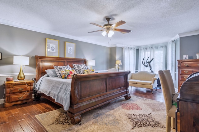 bedroom with ceiling fan, a textured ceiling, dark hardwood / wood-style floors, and ornamental molding