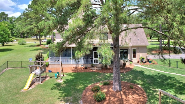 back of house featuring a sunroom and a yard