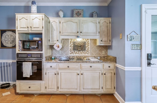 kitchen featuring light stone counters, black oven, backsplash, and light tile patterned flooring