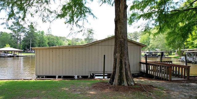 view of side of home with a dock and a water view