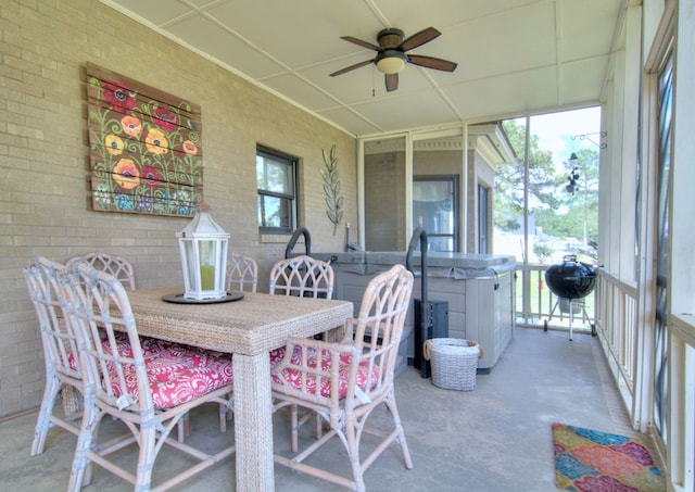 sunroom / solarium featuring ceiling fan