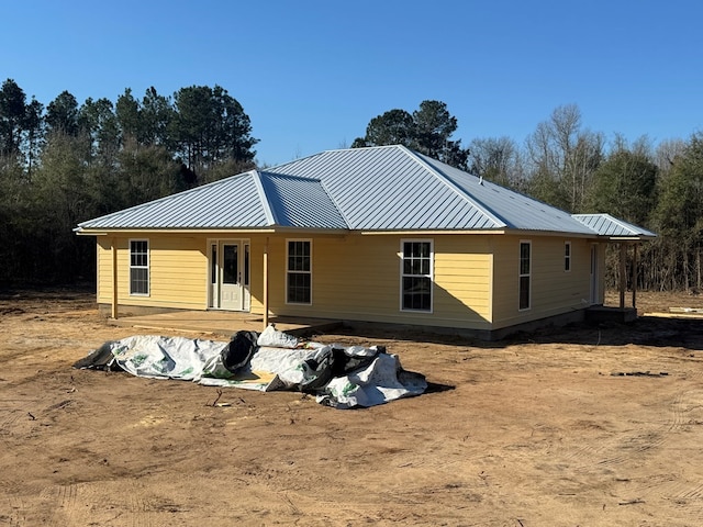 rear view of property with metal roof and a standing seam roof