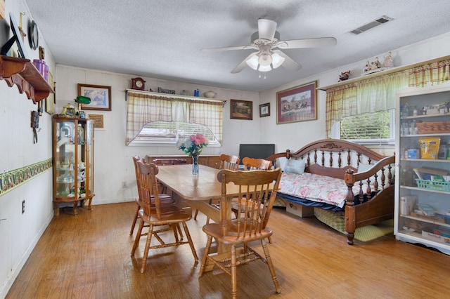 272 Ellis Rd, Plains, GA 31780 - dining room with a textured ceiling, a ceiling fan, wood finished floors, and visible vents