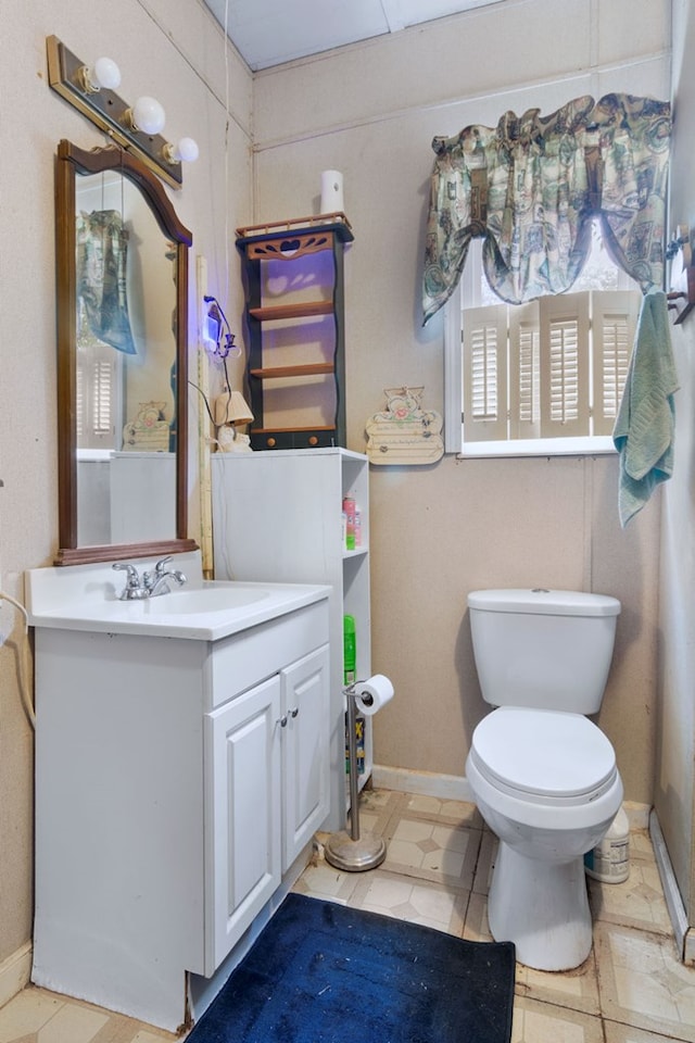 272 Ellis Rd, Plains, GA 31780 - bathroom featuring toilet, baseboards, and vanity