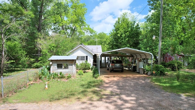 272 Ellis Rd, Plains, GA 31780 - view of front of property featuring fence, a detached carport, an outdoor structure, and driveway