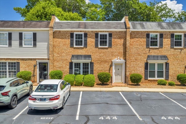444 Kingswood Ct, Albany, GA 31707 - colonial-style house with uncovered parking, a shingled roof, brick siding, and a chimney