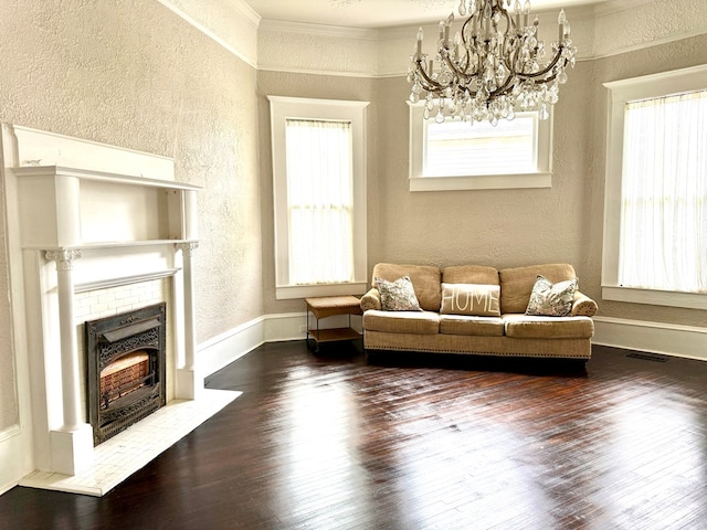 living room featuring ornamental molding, dark hardwood / wood-style floors, and an inviting chandelier