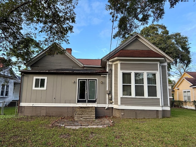 rear view of house with a yard