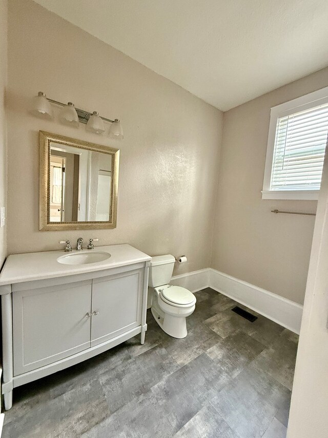 bathroom featuring toilet and vanity