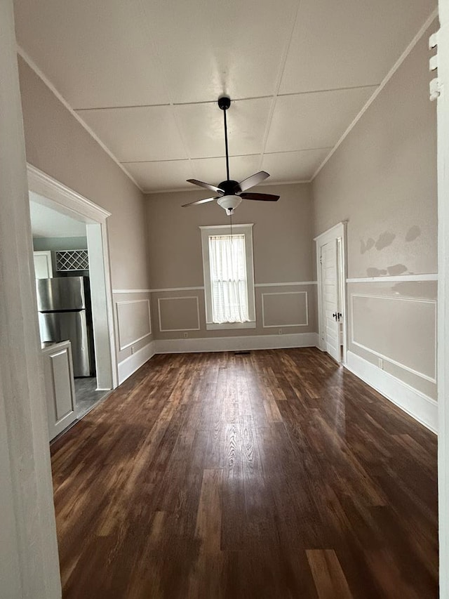 spare room featuring ornamental molding, ceiling fan, and dark hardwood / wood-style flooring