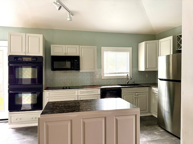 kitchen featuring sink, black appliances, white cabinetry, and a kitchen island