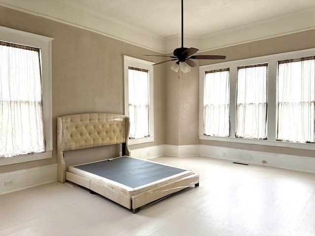 bedroom with ceiling fan and ornamental molding