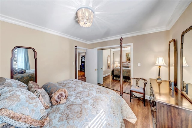 bedroom with hardwood / wood-style flooring, a closet, and crown molding