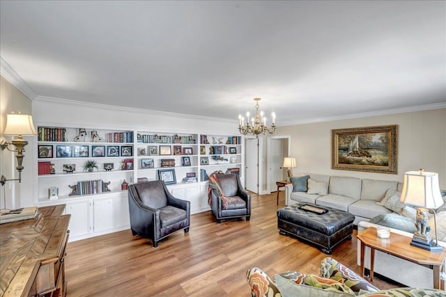 living room featuring built in features, light hardwood / wood-style flooring, an inviting chandelier, and crown molding