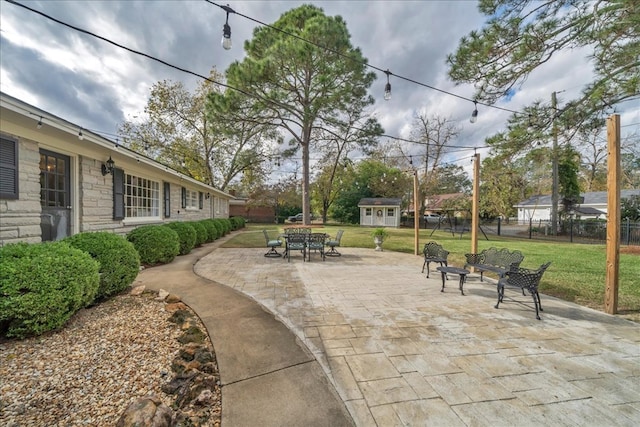 view of patio with a storage unit