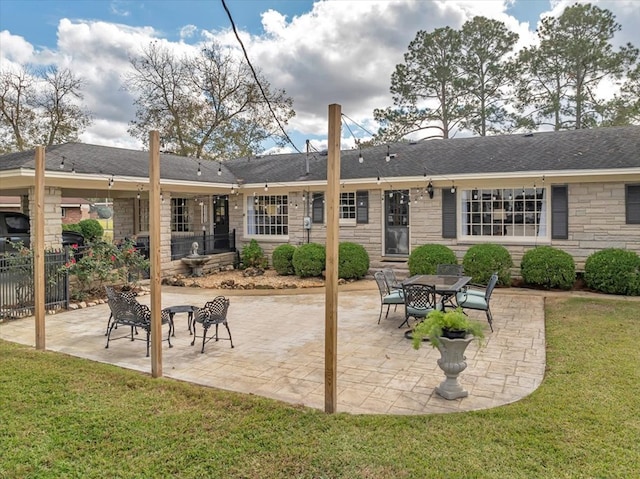 back of house with a patio and a yard