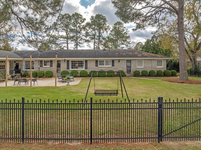 back of property featuring a lawn and a patio