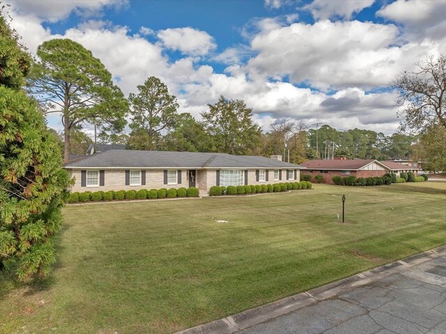 ranch-style house with a front lawn