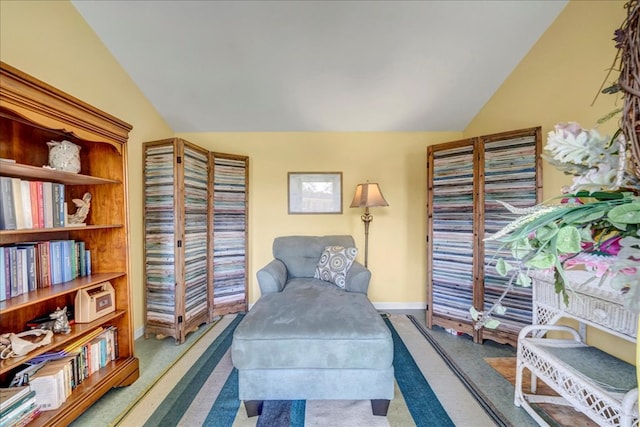 living area featuring carpet and lofted ceiling