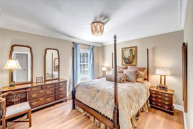 bedroom with hardwood / wood-style floors and ornamental molding