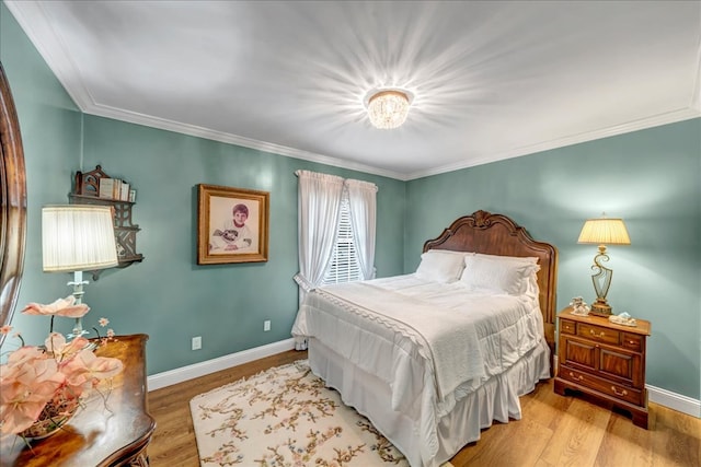 bedroom featuring crown molding and light wood-type flooring