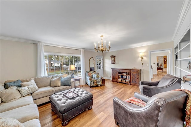 living room with light hardwood / wood-style floors, crown molding, and a chandelier