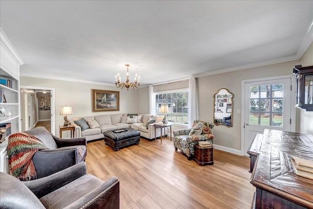 living room with crown molding, light hardwood / wood-style floors, and an inviting chandelier