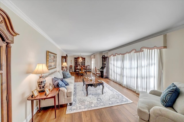 living room with light wood-type flooring and ornamental molding