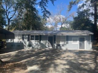 ranch-style house featuring a carport