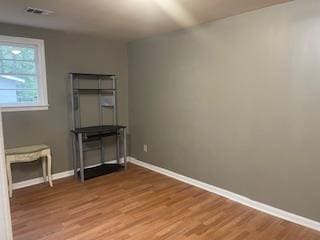 unfurnished room with hardwood / wood-style floors