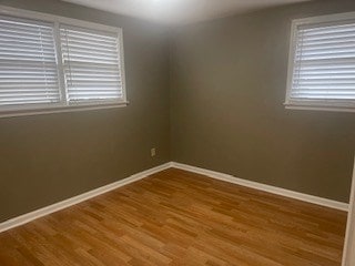 unfurnished room with hardwood / wood-style flooring