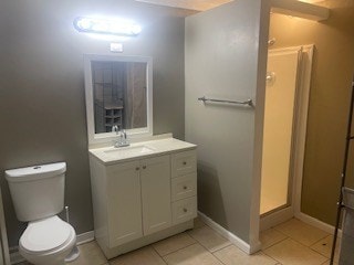 bathroom featuring a shower, toilet, vanity, and tile patterned flooring