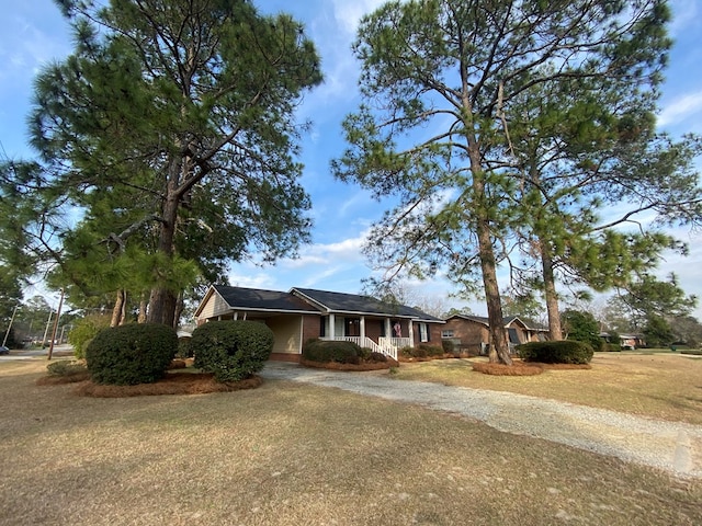 view of front of home with a front yard and a porch