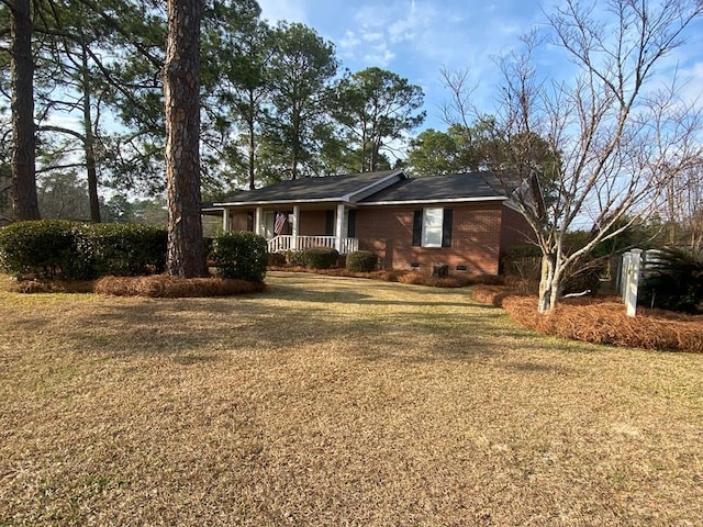 ranch-style home with a front yard and a porch