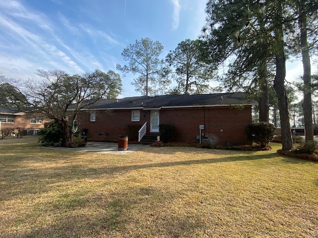 rear view of property with a lawn