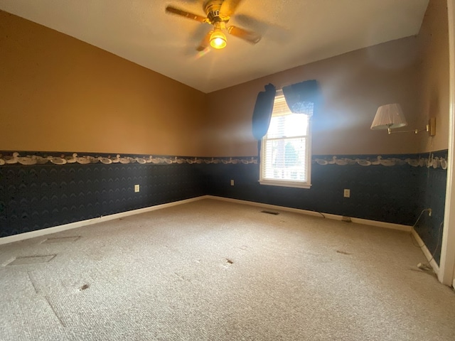 unfurnished room with vaulted ceiling, carpet floors, and ceiling fan