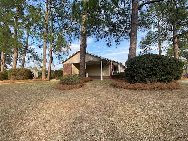 view of side of property with a lawn