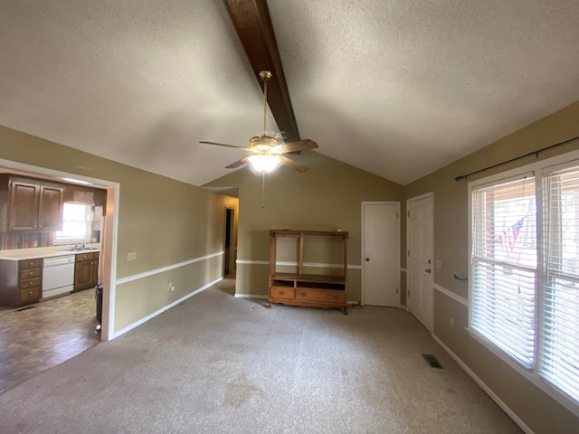 spare room featuring sink, light colored carpet, lofted ceiling with beams, a textured ceiling, and ceiling fan