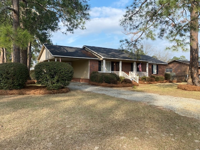 single story home with a porch and a front yard