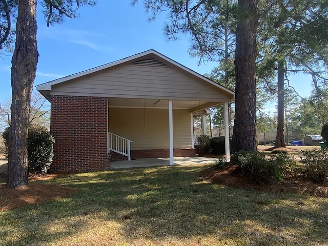 view of side of property with a lawn