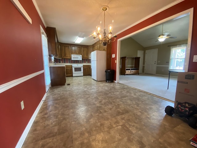 kitchen with crown molding, lofted ceiling, pendant lighting, and white appliances