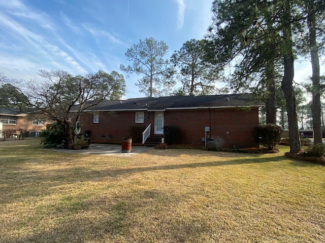 rear view of property with a yard